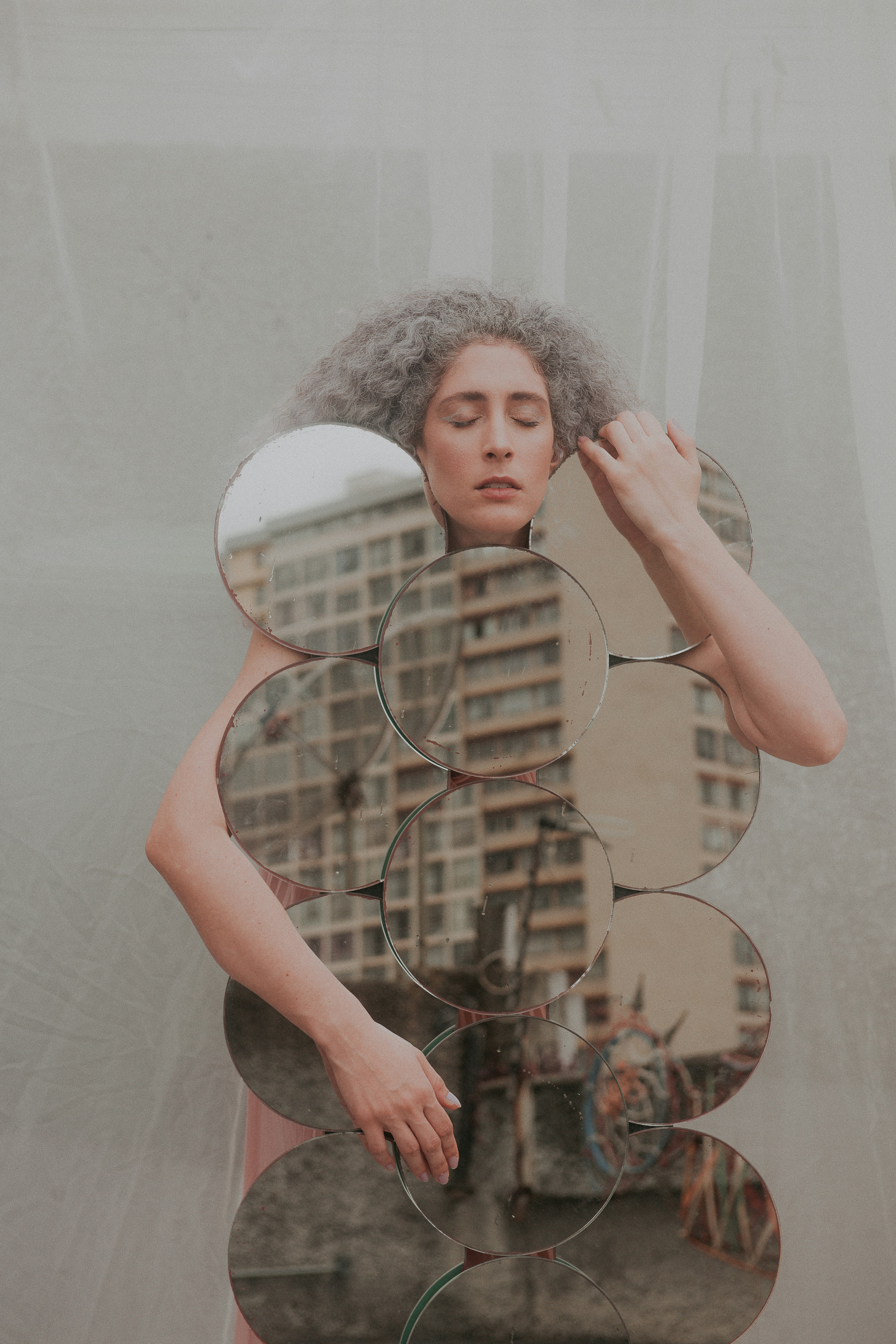 woman in black tank top holding mirror